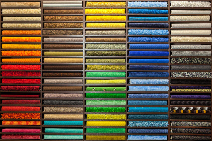 Samples of multi-colored carpets on the shelves